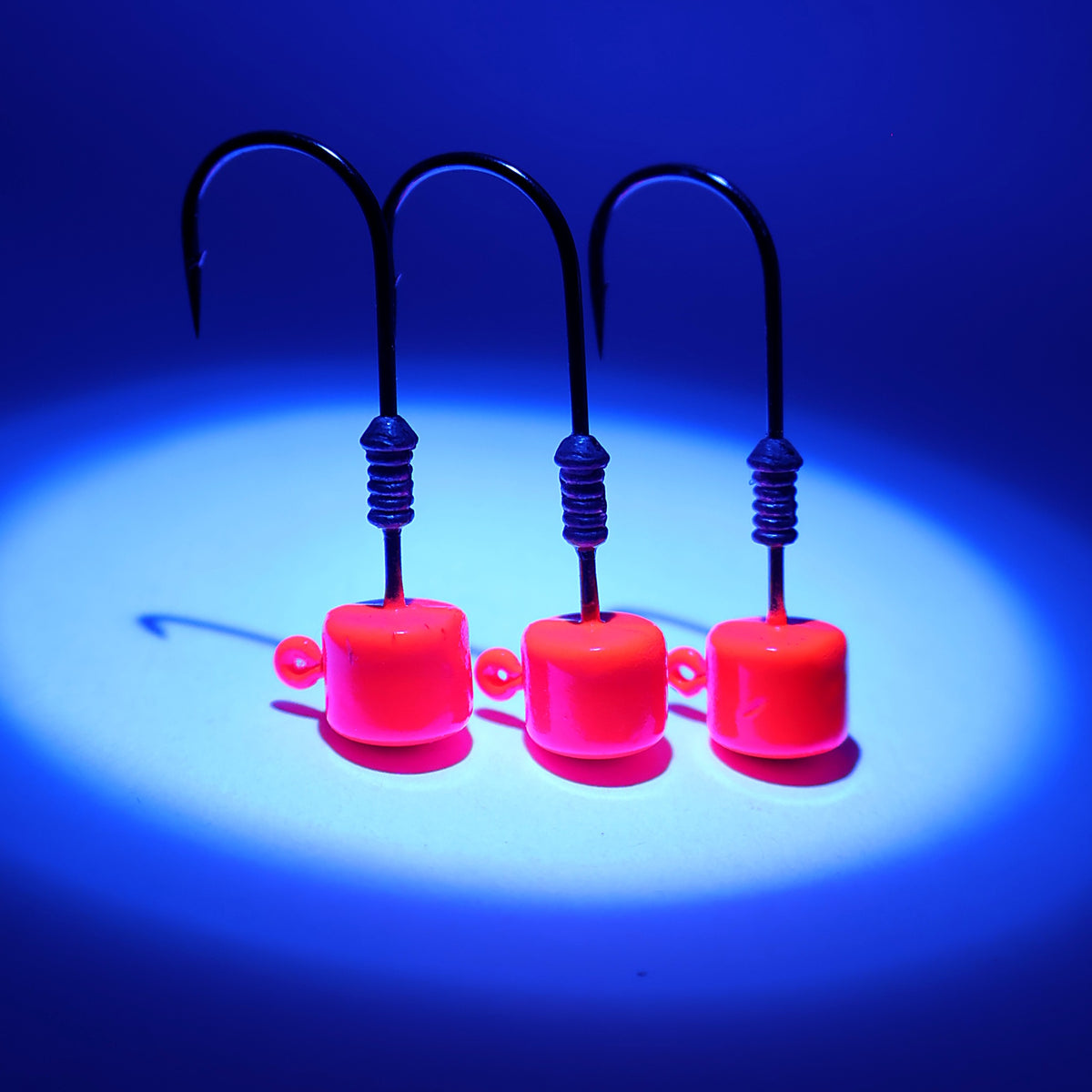S Tackle Glow Strike Pink mushroom jig heads glowing under UV light